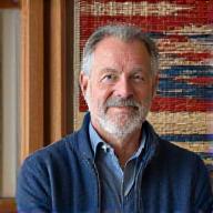 Malik working at a traditional vertical loom